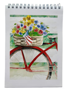 This is a watercolor of a red cruiser bicycle and behind the seat is a basket full of yellow blue and pink pansies with a small American flag dangling over the edge. This bike is leaning against a white fence.