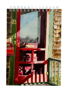 A red screen door with the early morning sun creating great shadows on the door and the green trim surrounding the door.