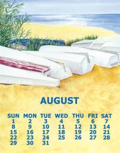 Load image into Gallery viewer, A beach-themed calendar page for August, featuring a watercolor-style illustration of white boats on yellow sand with blue ocean and sky in the background. The word AUGUST appears in large blue letters above a grid of days from Sunday to Saturday.