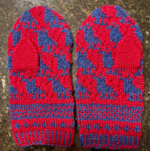 Load image into Gallery viewer, Pair of red and blue custom knitted mittens with a pattern on a textured surface
