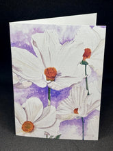 Load image into Gallery viewer, A hand cut greeting card with a cosmos floral design, featuring large white flowers with orange centers on a purple background, includes an envelope.