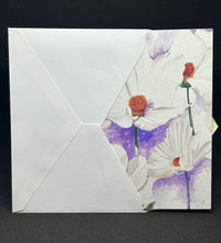 Load image into Gallery viewer, The cosmos card being inserted into an envelope