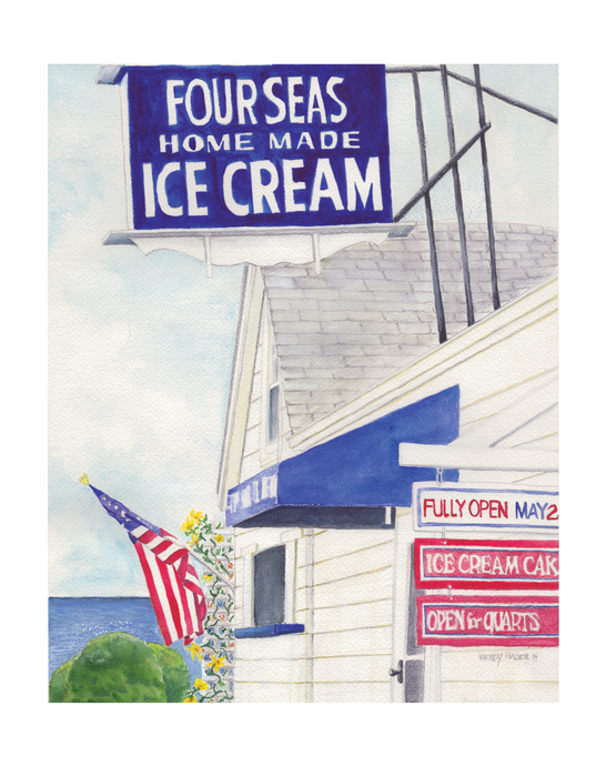 The American Flag is softly moving in the breeze.  While the signs indicate when Four Seas Ice Cream will open for the season.  White, Blue and Red are the major colors.