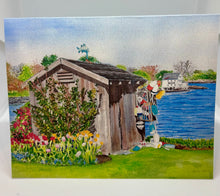 Load image into Gallery viewer, This is a watercolor of a New Castle, NH Garden Shed with red and yellow tulips and the Piscataqua Cafe in the distance across the cove.  it is early spring.  And there is a fish cupola on top of the wee shed