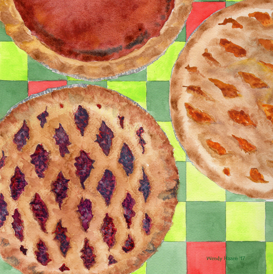 A dark green, light green and red table cloth with 3 holiday pies, pumpkin, peach and blueberry.