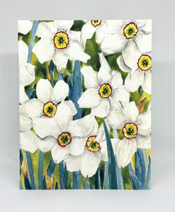 White Jonquils with the blue gray leaves and the yellow centers with a red ring around the center of each jonquil.
