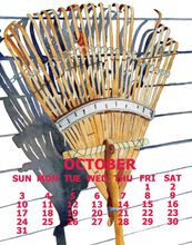 Load image into Gallery viewer, Vintage-style calendar page showing a large wooden garden rake against a white background with a cast shadow. The word OCTOBER appears in large red letters, with the days of the week and numbers for October listed below in red.