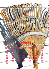 Load image into Gallery viewer, A watercolor-style calendar page showing an illustrated rake with a October schedule grid printed over it. The rake is rendered in warm tan and brown tones with blue-gray shadows, and the days of the week are listed in red text at the bottom.