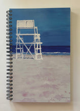 Load image into Gallery viewer, A lifeguard stand on a beach looking to the sea before a storm.
