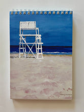 Load image into Gallery viewer, a tall white lifeguard stand looking towards the brewing ocean