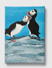 Load image into Gallery viewer, Two puffins on a rocky surface with a blue sky background