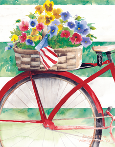 This red bike with the woven basket  of colorful Pansies  behind the seat lives in West Barnstable on Cape Cod