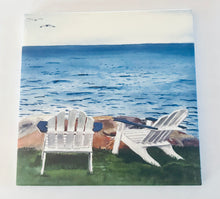 Load image into Gallery viewer, Two Adirondack chairs sitting on the lawn facing the water with a large rock in place. 