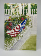Load image into Gallery viewer, White front porch with a hammock in the background.  A flower window box with an American flag 