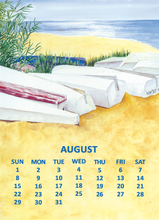 Load image into Gallery viewer, August calendar page featuring a watercolor beach illustration with white boats on yellow sand, blue ocean, and green foliage, with the days of the week printed in blue at the bottom.