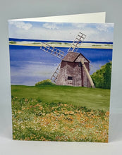 Load image into Gallery viewer, A greeting card featuring a hand-cut card design with an illustration of a windmill on Cape Cod, water, and a field. The card is open, displaying the inside.