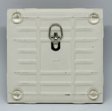 Load image into Gallery viewer, back of a PLAIN tile with 4 bumpons and a folding medal hanger.