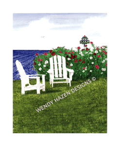 Adirondack chairs with a cosmos garden, birdhouse and the sea beyond