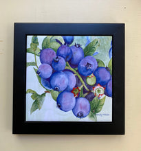 Load image into Gallery viewer, A ceramic tile of blueberries on a leafy green background framed in a black wooden frame