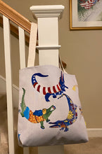 Load image into Gallery viewer, A canvas bag with a colorful painting of dancing alligators, on both sides.  Inspired by Naples, FL sculpted alligators throughout the downtown area - 5th and 3rd Avenue