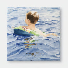 Load image into Gallery viewer, A ceramic tile of a 5 year old with his sipderman inner tube swimming along.