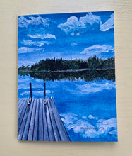 Load image into Gallery viewer, A hand-cut greeting card with an illustration of a pond and a dock, featuring a blue sky with clouds and a reflection in the water.