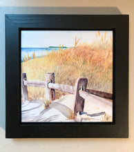 Load image into Gallery viewer, The Beach Path in a Black Wooden Frame.  The weathered split rail fence leading towards the beach with the fall seagrass beyond.  On the horizon is Cape Cod Bay looking towards Wellfleet.