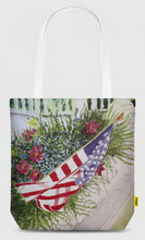 Load image into Gallery viewer, A canvas bag with a porch garden box filled with flowers and a flag!  Happy Fourth.  The same design on both sides