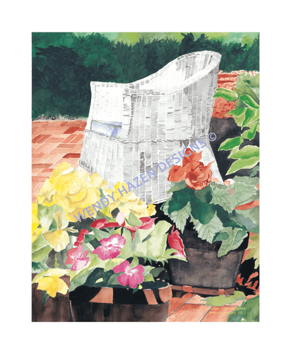 White wicker chair with a petunia garden